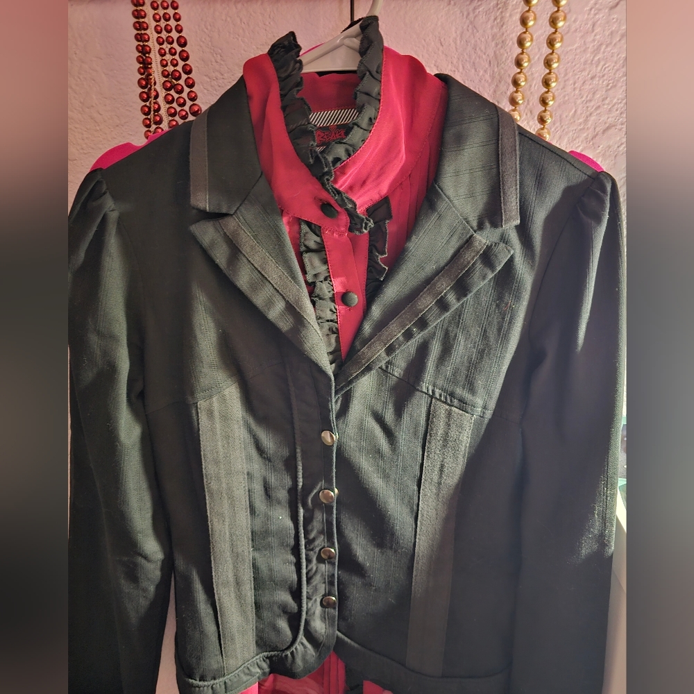 Blac blazer with a red long sleeve blouse